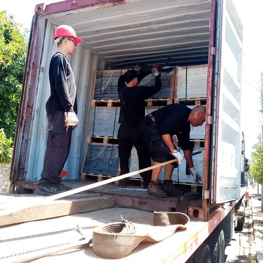 Equipo de Grúas Sotomayor descargando pallets desde el interior del contenedor